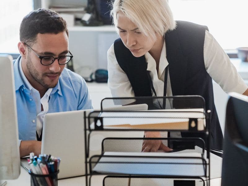 IT consultancy: Two colleagues working at a laptop. Photo by Mizuno Kozuki on Pexels.