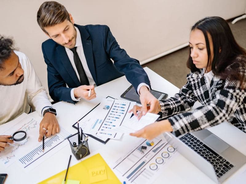 Professional services: Colleagues reviewing charts in a meeting. Photo by Yank Rukov on Pexels.